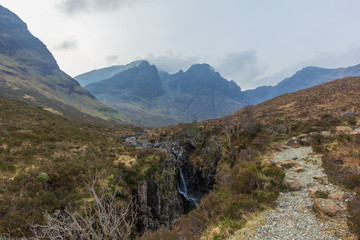 On the way to the Bla Bheinn mountain with a water fall and a majestic rocky mountain