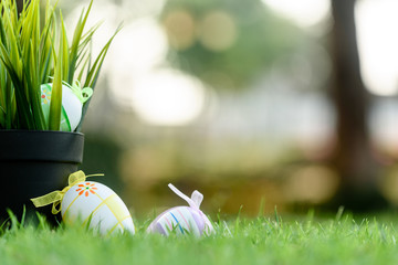 Fototapeta premium Decorated Eggs lay on grass prepared for Easter celebration