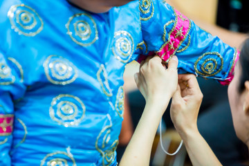 The process of dressing the Thai pantomime for the actors with hand sewing, repairing,