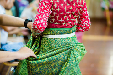 The process of dressing the Thai pantomime for the actors with hand sewing, repairing,