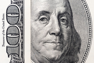 Benjamin Franklin's eyes from a hundred-dollar bill. The face of Benjamin Franklin on the hundred...