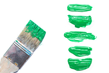isolated green paint stain and bursh