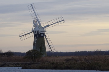 Sunset over St Benets Drainage Mill. Thurne, Norfolk Broads, England, UK