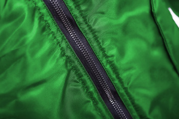 Close up of green jacket zipper , winter fashion outfit. Jacket isolated on white background. © Zoran