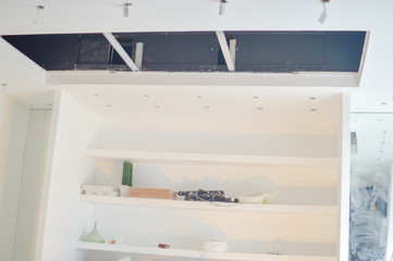 Electric sockets light works mounting and installation on plaster wall background. Professional installation of electrical outlets, wires and switches. Close up side view.