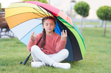 Find peaceful private space to relax. Under big umbrella. Girl child long hair meditate park under umbrella. Stay positive and optimistic. Colorful accessory positive influence. Bright umbrella © be free