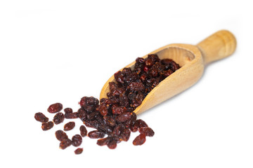 Closeup of dried red barberries, a good source of vitamin C, presented on a small wooden scoop