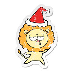 distressed sticker cartoon of a bored lion wearing santa hat