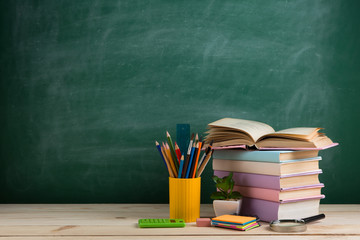 Education concept - books on the desk in the auditorium