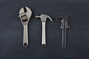 Repair concept - tools on the grey background, flat view, copy space