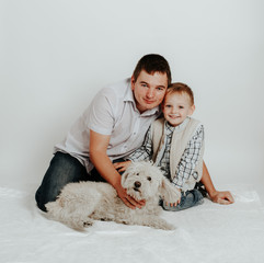 Family father and boy sit with dog