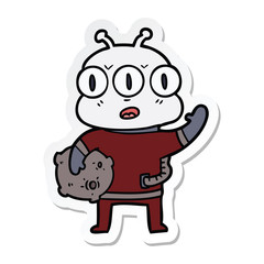 sticker of a cartoon three eyed alien waving