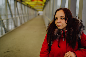 Fototapeta premium Beautiful girl on the bridge, looking into the distance