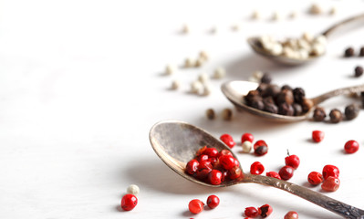 Pink peppers in spoon, copy space