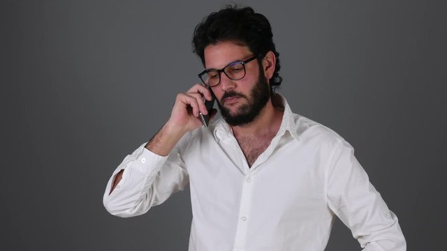 Young businessman emotionally talking on the phone.