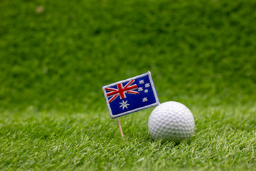 Golf ball with Australia flag are on green grass