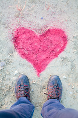 man standing above a heart