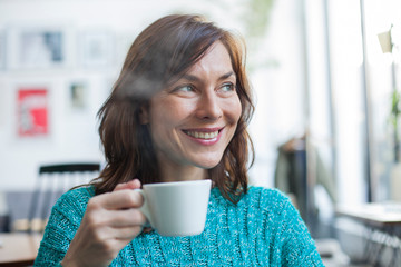 woman drinking coffee in a cafe