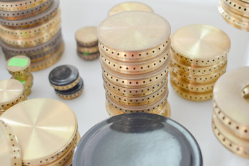 Gas plates spare parts for cooker, product shopping display background. Closeup on golden and gray shiny round shape elements of household appliance.