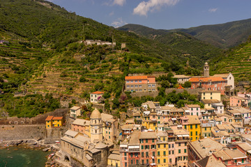 Fototapeta na wymiar Italy, Cinque Terre, Vernazza, Vernazza, HIGH ANGLE VIEW OF TOWNSCAPE AND MOUNTAINS AGAINST SKY