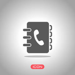 address book with phone sign on cover. simple icon. Icon under spotlight. Gray background