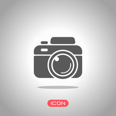 Photo camera, simple icon. Icon under spotlight. Gray background