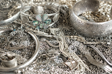 Close up of various silver jewelry items