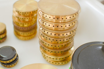 Gas plates spare parts for cooker, product shopping display background. Closeup on golden and gray shiny round shape elements of household appliance.