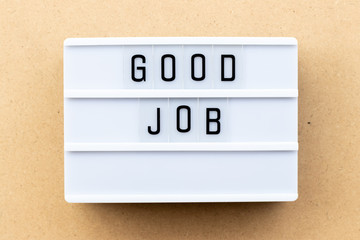Light box with word good job on wood background