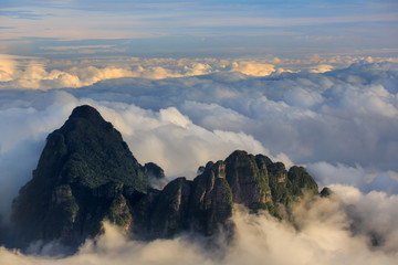 Chinese Karst Mountains above the clouds, steep cliffs covered in exotic trees. Dayao Mountain range near Jinxiu City, Guangxi Province China. Shengtang Mountain, Shengtangshan. Hiking and Travel