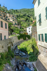 Fototapeta na wymiar Italy, Cinque Terre, Vernazza, a stone building that has a rock wall