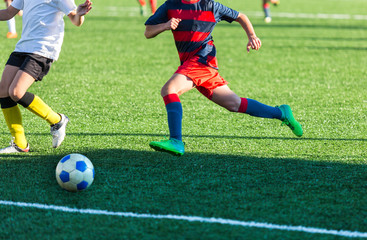 Football training soccer for kids. Boy runs kicks dribbles soccer balls. Young footballers dribble and kick football ball in game. Training, active lifestyle, sport, children activity concept 