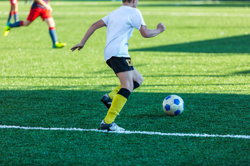 Football training soccer for kids. Boy runs kicks dribbles soccer balls. Young footballers dribble and kick football ball in game. Training, active lifestyle, sport, children activity concept 