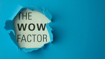 Torn paper with text The wow factor. Motivational concept