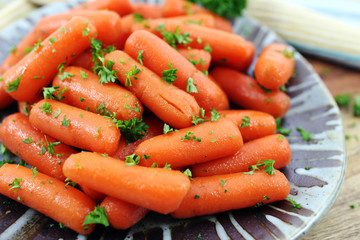 Honey glazed baby carrots with parsley, close up