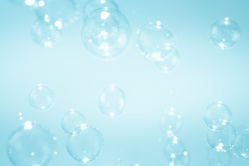 abstract background with soap bubbles floating on blue background.