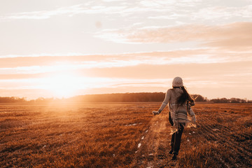 girl running in golden fields