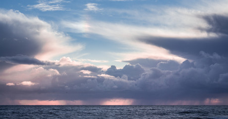 Naklejka na ściany i meble Beautiful clouds over ocean