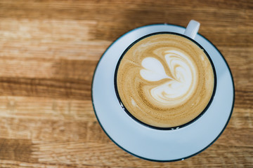 cup of coffee on wooden table