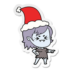 annoyed sticker cartoon of a vampire girl wearing santa hat