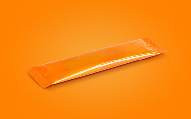 blank packaging aluminum foil instant coffee stick sachet isolated on orange background