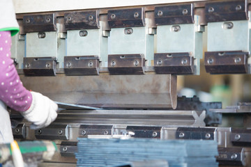 Sheet metal bending ,Operator working cut and bending metal sheet