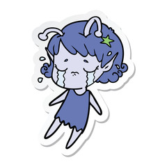 sticker of a cartoon crying alien girl