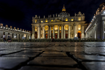 Obraz premium Vatican City,Italy - 23 June 2018: St.Peters Basilica is illuminated with lights at night in Vatican city in the square with moonlight at night