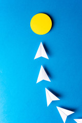 Idea, imagination, solution, light bulb concept. Paper white airplanes with yellow point on blue background.