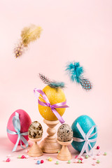 Fototapeta na wymiar Easter composition with decorated eggs and flying feathers