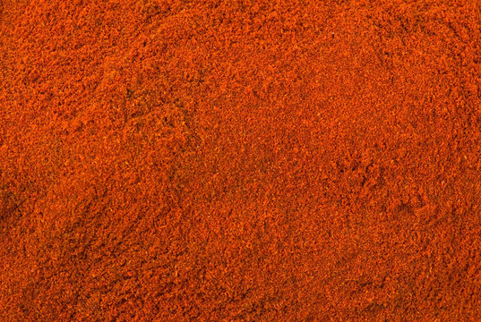 milled or ground paprika or red pepper background. Natural seasoning texture. Natural spices and food ingredients.