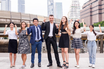 Fototapeta premium Successful diversity group of business people,Teams success standing and achievement hand raised up outdoor in the city