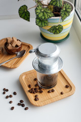 alternative method of brewing coffee. Filter with ground coffee and glass. vietnamese filter for espresso. morning routine concept