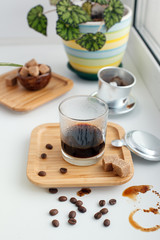 Alternative coffee brewing method set. Stylish accessories and items for alternative coffee on windowsill. Espresso in glass, coffee beans, filters